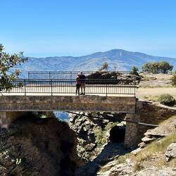 When we crossed this bridge on our bikes, we had no idea there was a hidden waterfall just below us.