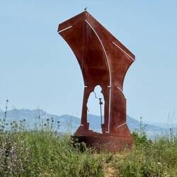 Represents Santo Domingo inside the pillar of a bridge; he was known for building them for pilgrims.