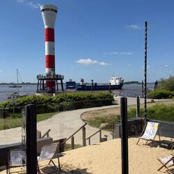 im Strandcafé mit Blick auf Leuchtturm und Elbe