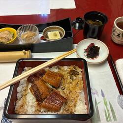 My luncheon of broiled eel, plus pickles, other condiments, soup, and tea