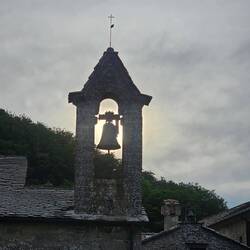 The rising sun behind the bell