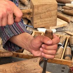 Watching a wood carver