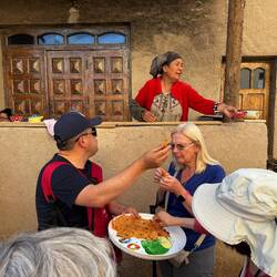 Sharing the bread around, Mama passing tea around