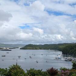 Patches of blue sky, massive yacht in harbour