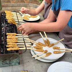 Satespiesse werden über Kokosschalenfeuer gegrillt