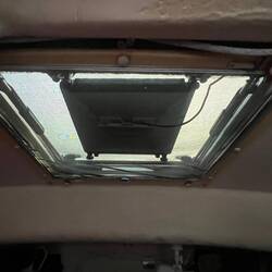 Starlink is attached by a holder underneath the V-Berth hatch.