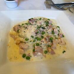Mushroom ravioli with cream, peas, smoked chicken