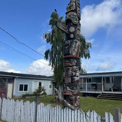 Totem pole in front of Fort Rupert residence