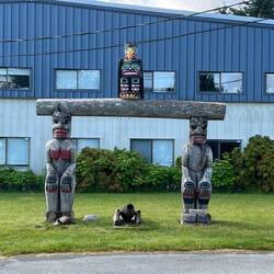 Totems in front of Kwakiutl Band Administration Building, Fort Rupert