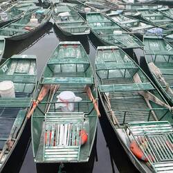 Sampans lined up at Tam Coc lakeside ready to take tourists out on the rivers.