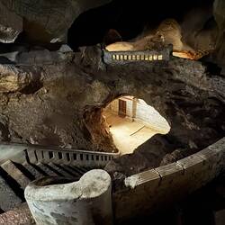 ... into the dark, up stairs into the cave’s height, and out the other side to see a small shrine.