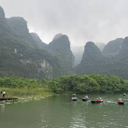 Trang An. A 2hr boat trip along a green river with karst peaks, ancient temples and caves.