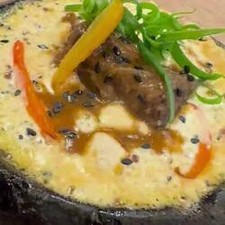 Hot fresh cheese with 8 hour Cow's cheek meat served in a stone.