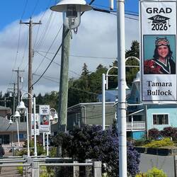 The city honors its grads with displays on the lights posts.
