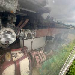 A large logging chain saw is inside the window also.