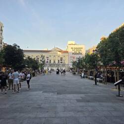 Theatre at end with restaurants on both sides of street