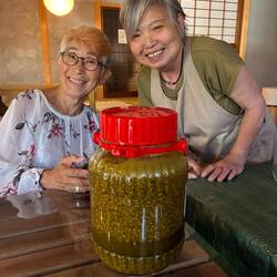 At a soy sauce making class, with the necessary fermenting rice and the teacher