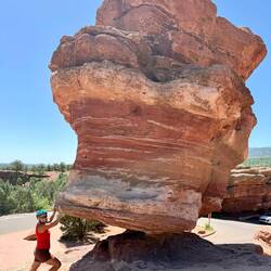 Beth trying to hold up or push over this rock!