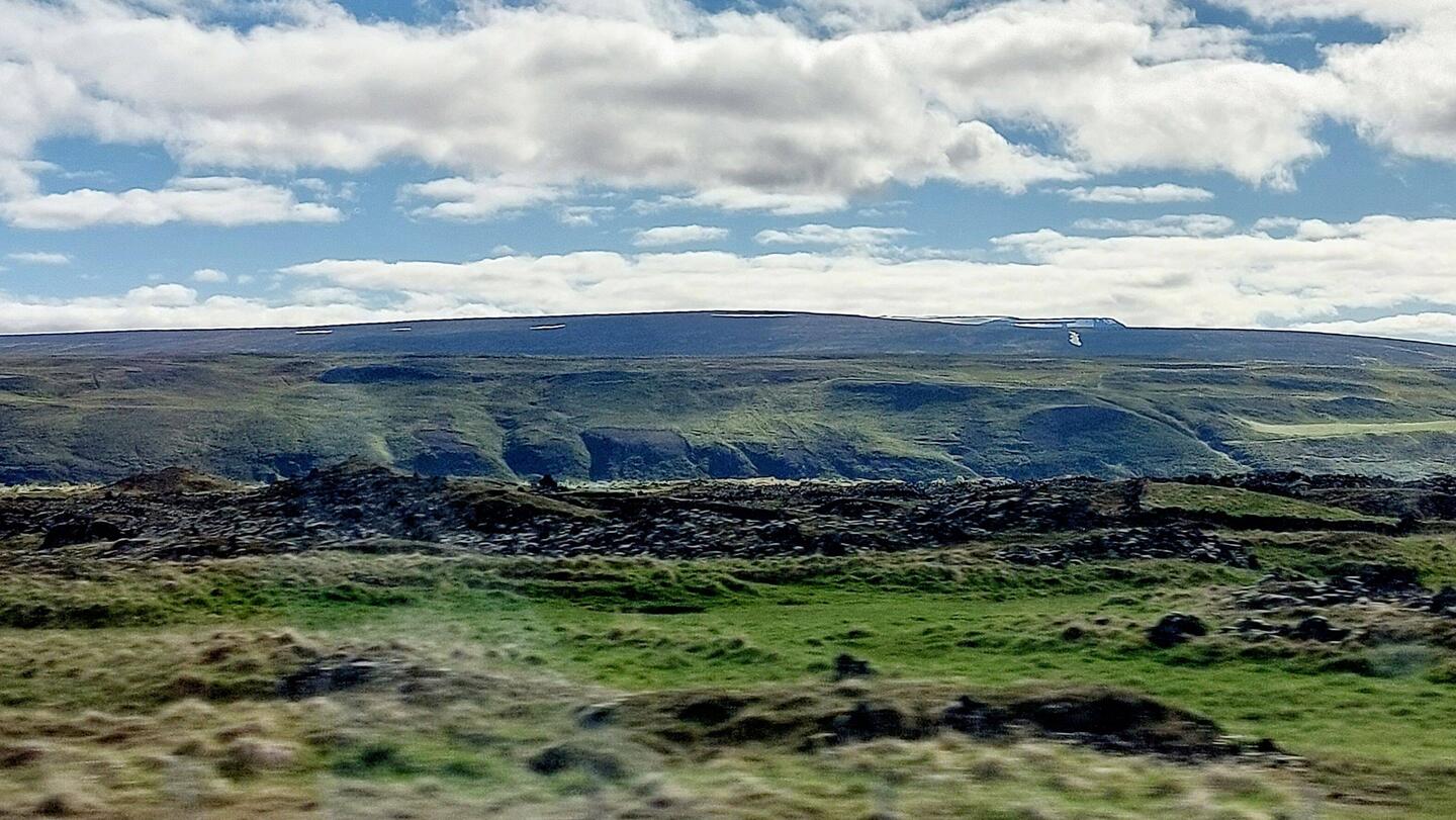 En route to Gudafoss; Pseudo-crater formed from lava pushing up from the ground