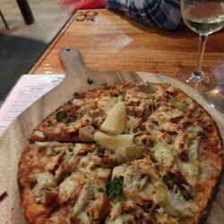 House smoked salmon pizza with artichoke and capers