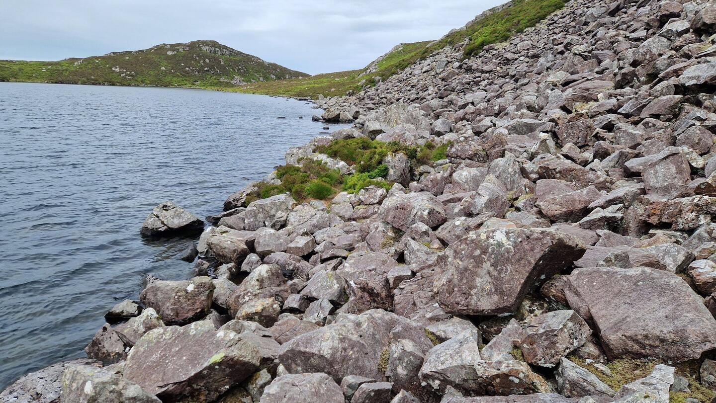 View west along the north shore of Llyn Hywel illustrating the large boulder traverse from my pitch