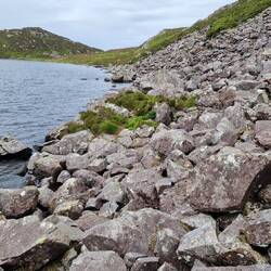 View west along the north shore of Llyn Hywel illustrating the large boulder traverse from my pitch