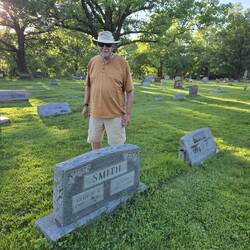 Phil by the marker for his grandparents on his mother's side. Cemetery better cared for.