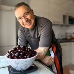 Weighing the pitted cherries to determine the sugar ratio.