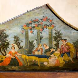 Bentside spinet lid painting depicting an outdoor concert w/a woman playing a harpsichord.