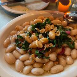 Fried beans with fried garlic and greens. Some vinegar