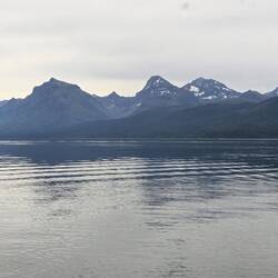 The morning is still except for a single fishing boat.