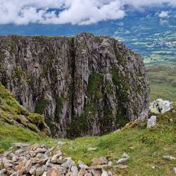 Dramatic cliff with Dolgellau in the distance viewed from Mynydd Moel