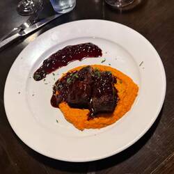 Elk medallions, smashed sweet potato, and huckleberry glaze—perfect end to the day.