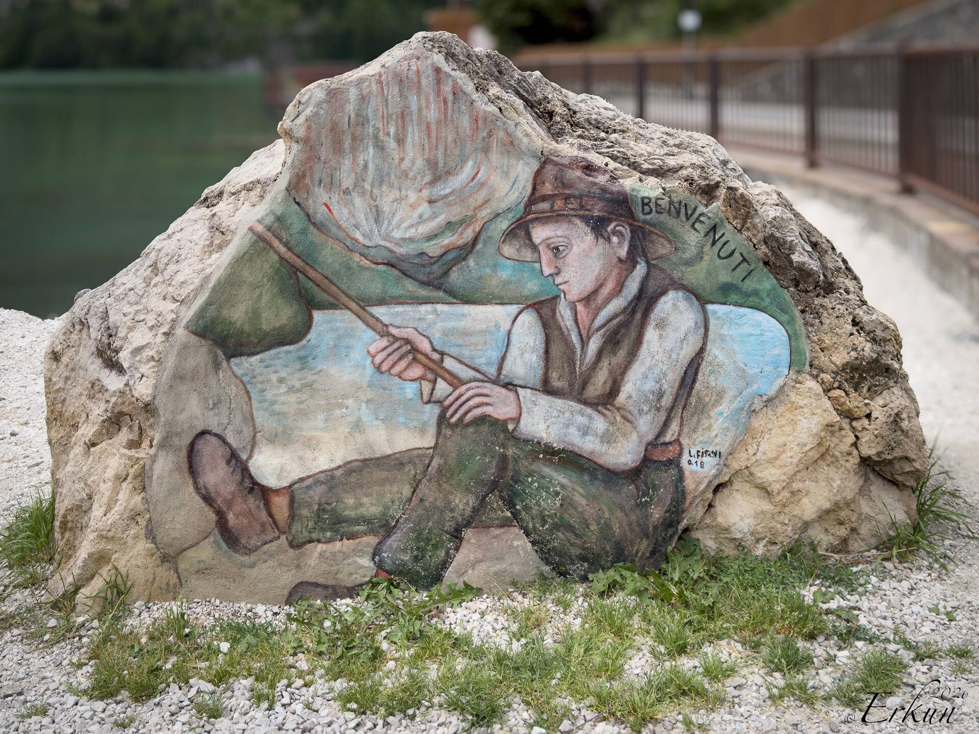 Greeted by a welcome mural at the start of the lakefront promenade — Alleghe, Italy.