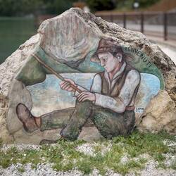 Greeted by a welcome mural at the start of the lakefront promenade — Alleghe, Italy.