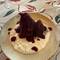 Pear poached in wine with cheese sauce.