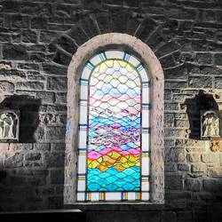 Brightly coloured stained glass windows feature