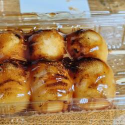 Mitarashi Dango - Rice flour dumplings with a sweet soy sauce glaze. They are very good!