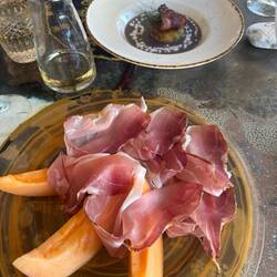 Prosciutto e melone and a broccoli flan with purple potato puree and bacon