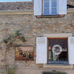 Two completely different windows balance another beautiful mosaic artwork in the main street