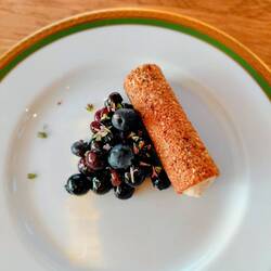 Thyme cream in a wafer with red berries