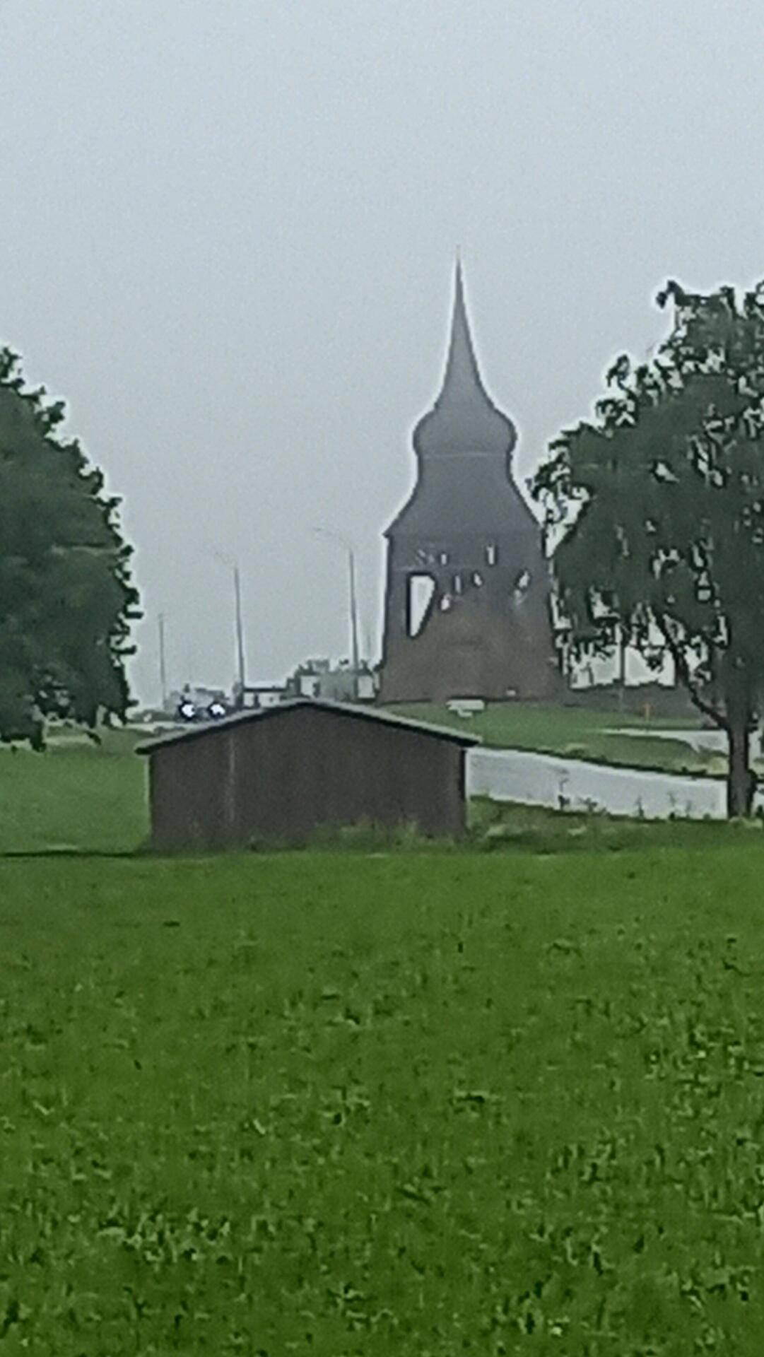 Froso kyrke belltower emerging from the rain
