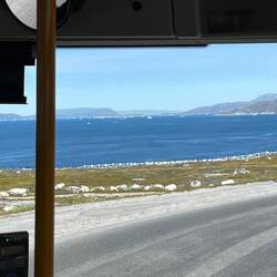 past icebergs and fjords.