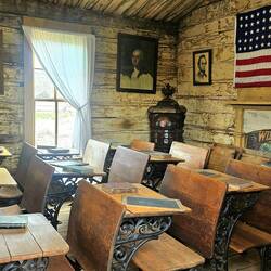 School room. 33 stars on the flag indicate it's from 1859-1861.