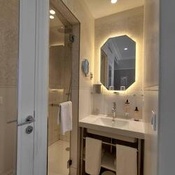Our compact bathroom, complete with wallpaper in the shower!
