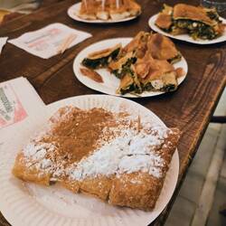 Traditional Spanikopita spinach pie, Cheese Pie, and Bugatza with cream