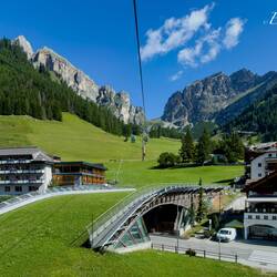 One of several ski bridges over the main road through the town — Colfosco, Italy.