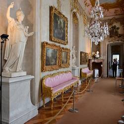 Note narrow settees, to balance the narrow room