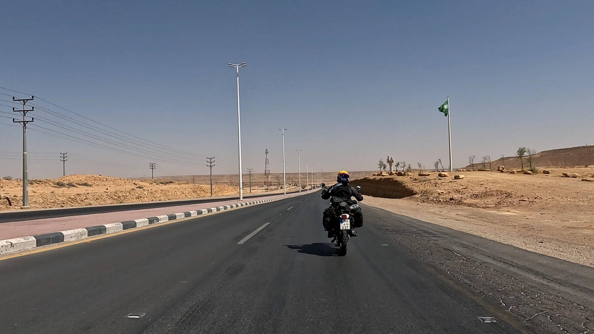 Riding under the waving Saudi flag