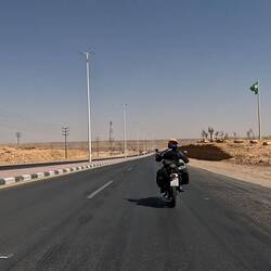 Riding under the waving Saudi flag